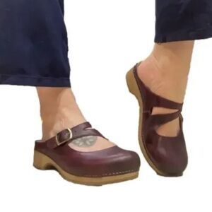 Dansko Britney clogs in a wine waxy burnished leather finish.